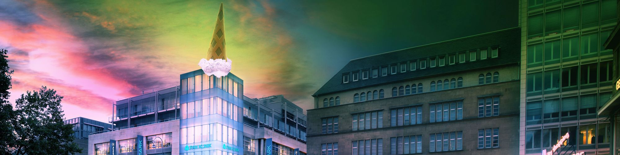 A modern building with a triangular spire topped by a large ice cream cone stands amidst adjacent structures. The sky above features vibrant colors, adding an artistic touch to the urban scene.